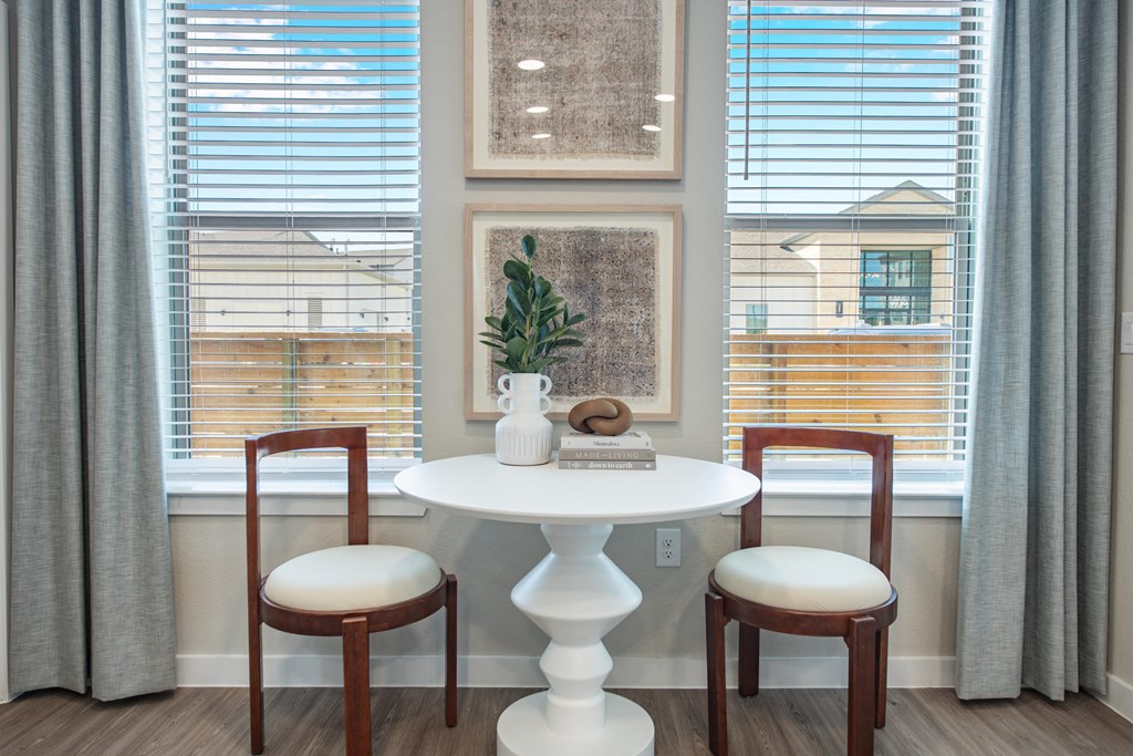 a dining room with a table and two chairs