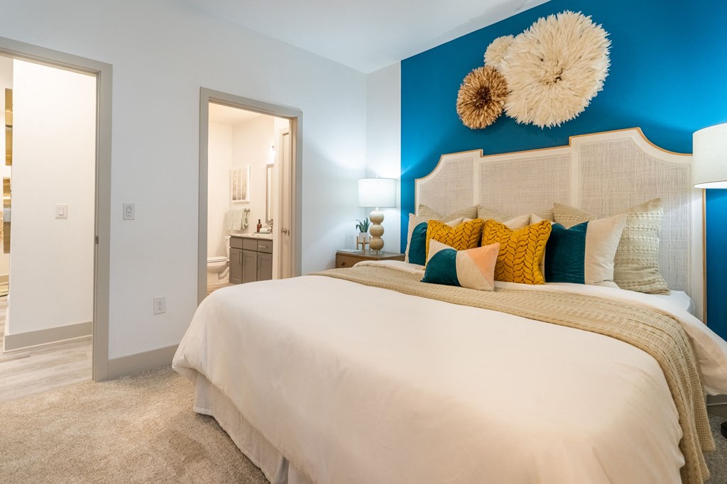 a blue and white bedroom with a large bed