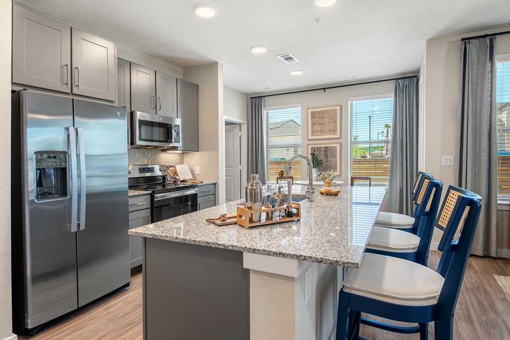 a kitchen with stainless steel appliances and a granite counter top