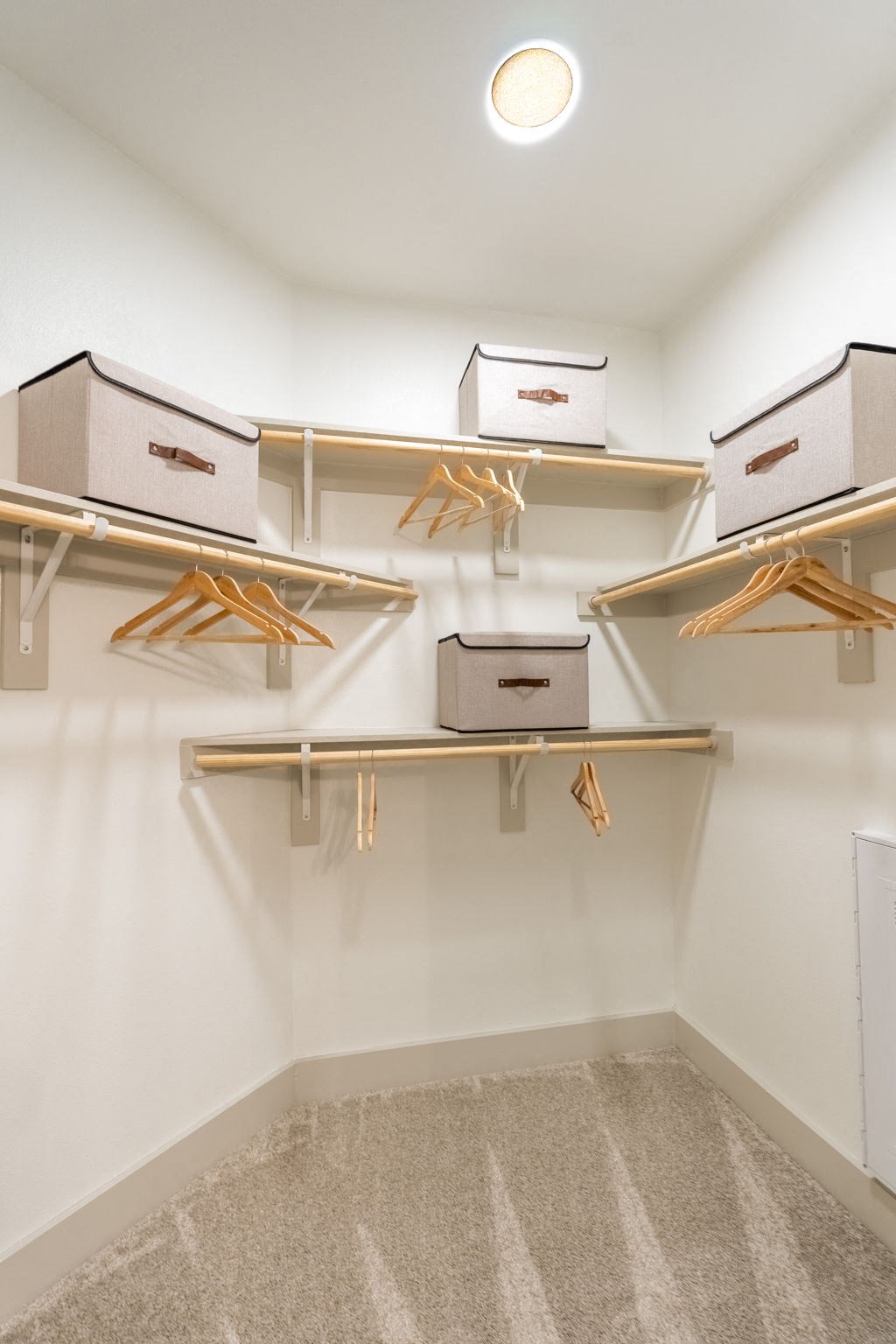 a spacious closet with shelves and storage boxes