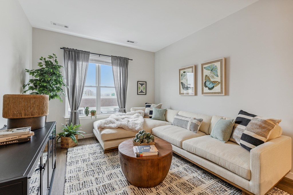 a living room with a couch and a coffee table and a window