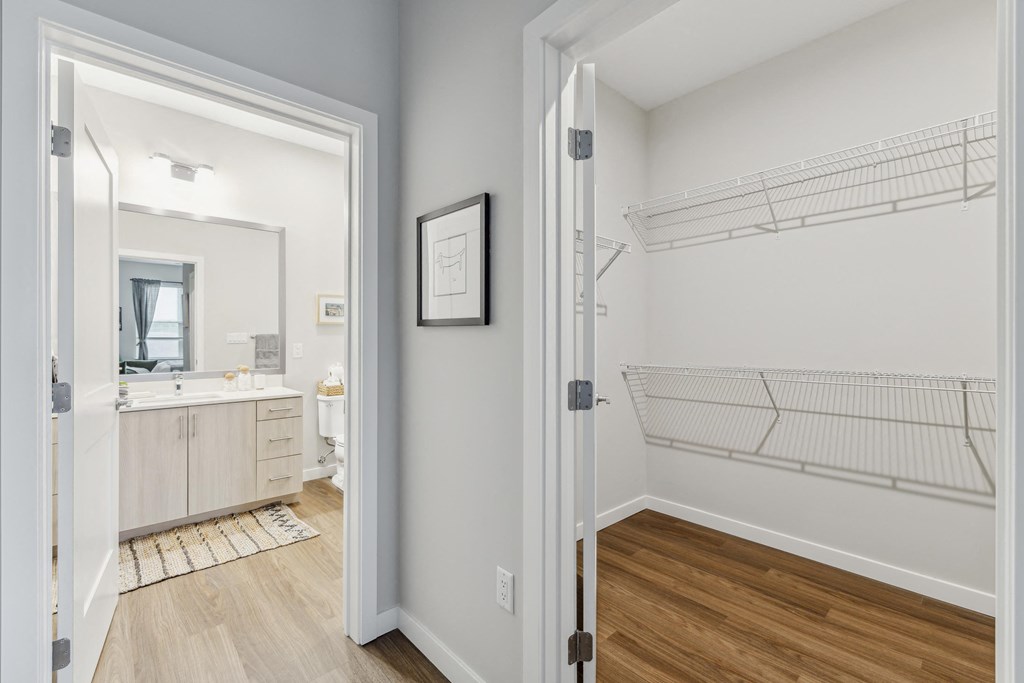 a bedroom with a door to a bathroom and a closet