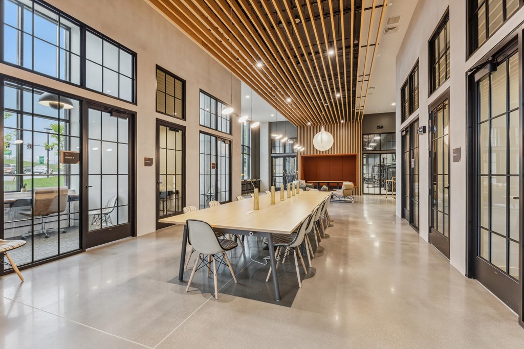 a large conference room with large windows and a long table with chairs