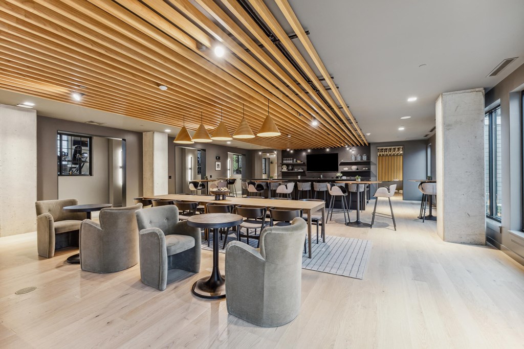 the lobby of a hotel with tables and chairs