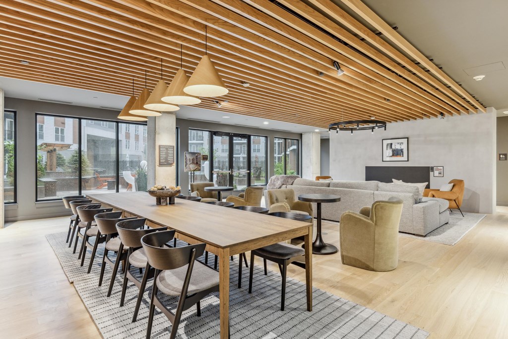 a living room with a long wooden table and chairs