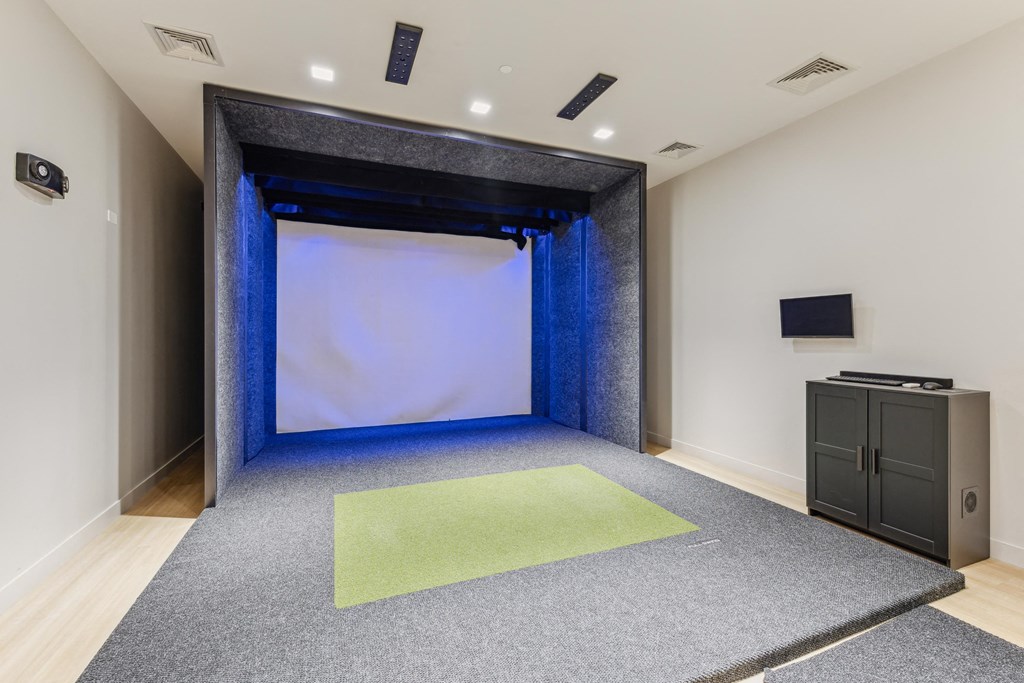 a large room with a screen and a projector