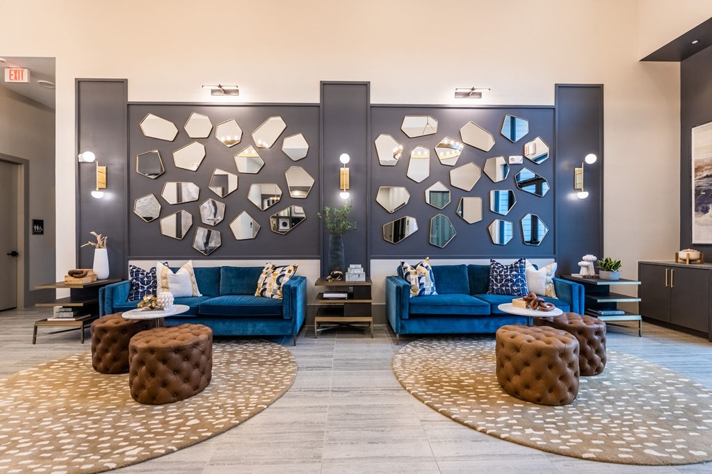 a lobby with blue couches and chairs