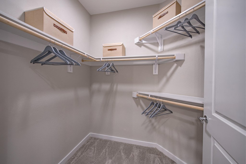 a spacious walk in closet with shelves and hangers