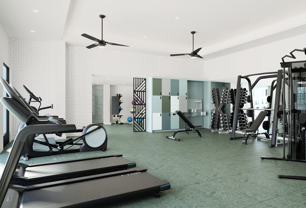 a gym with treadmills and other exercise equipment in a room with white walls