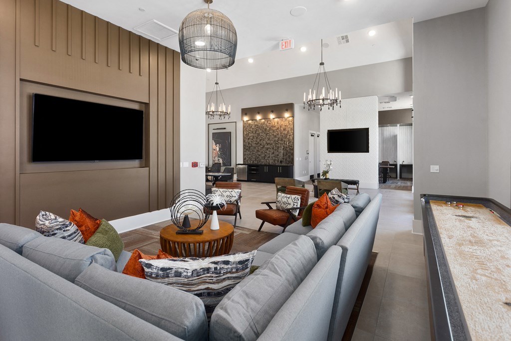 a large living room with couches and chairs and a television