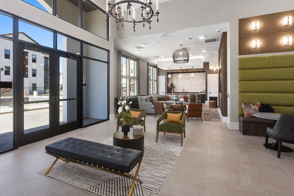 a lobby with a seating area and a large chandelier