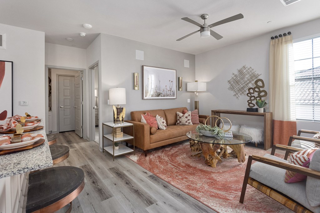 a living room with furniture and a ceiling fan