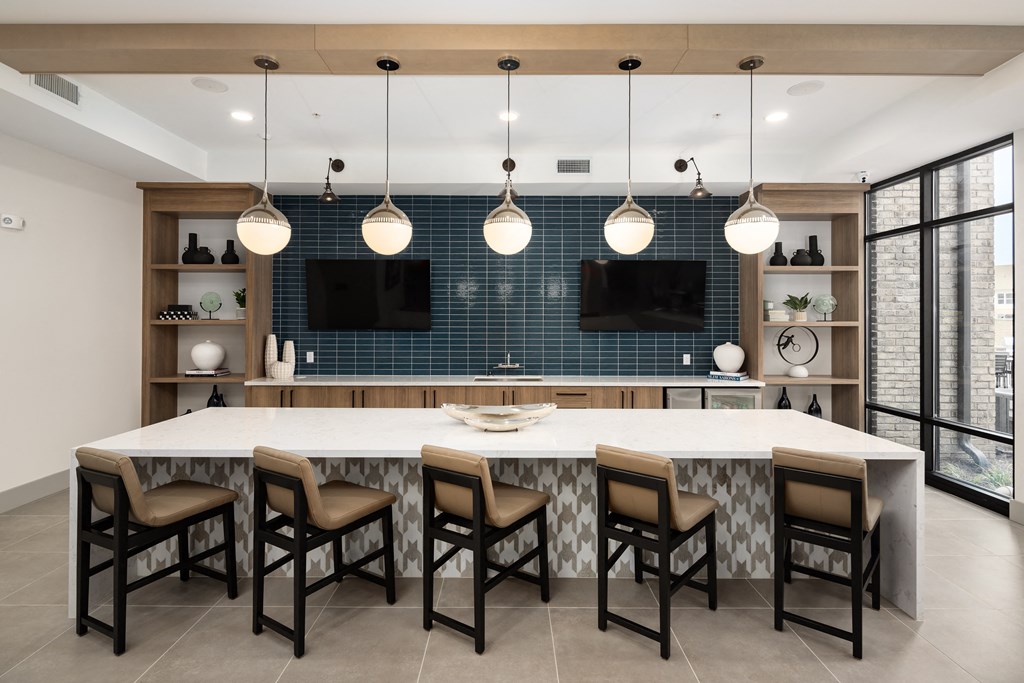 a large kitchen with a large island with chairs and a tv at Alta Northerly, Cumming, GA