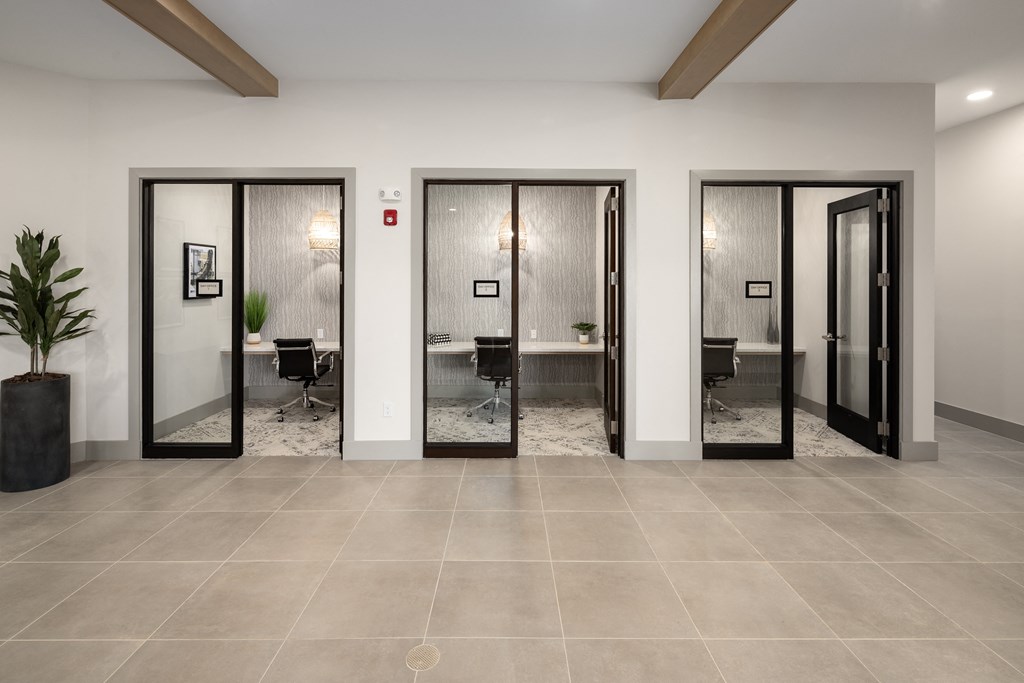 a lobby with four elevators and a table with chairs in itat Alta Northerly, Georgia, 30028