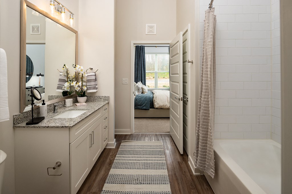 a bathroom with a shower and a tub and a sink and a mirror at Alta Northerly, Georgia