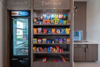 a vending machine with snacks in a room with a counter