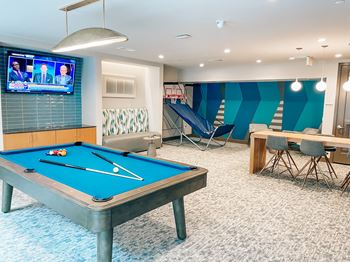 Entertainment spaces featuring tables, hi-def TVs, and billiards table