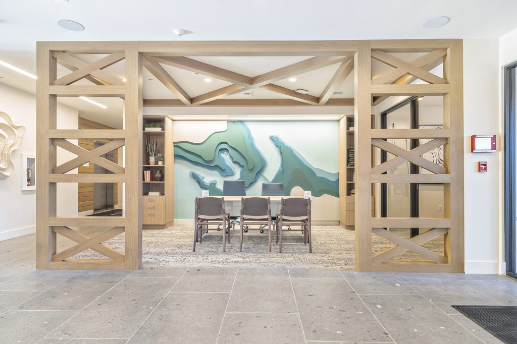 a dining room with a table and a painting on the wall