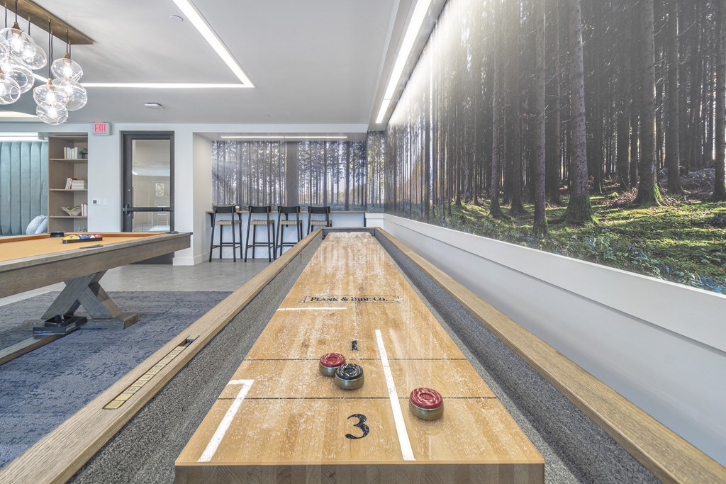 a ping pong table in the center of a room with a view of trees