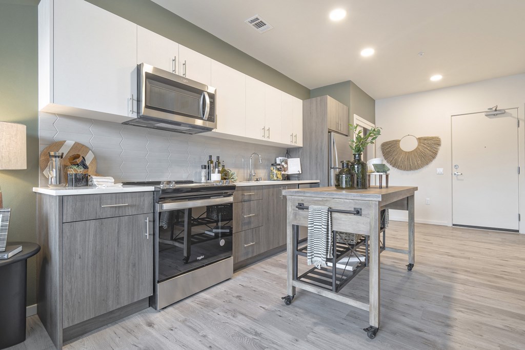 a kitchen with stainless steel appliances and a table