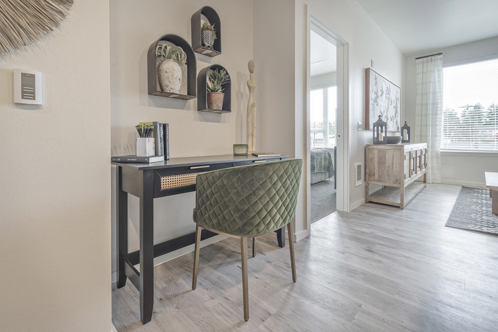 an office with a desk and a chair in a living room
