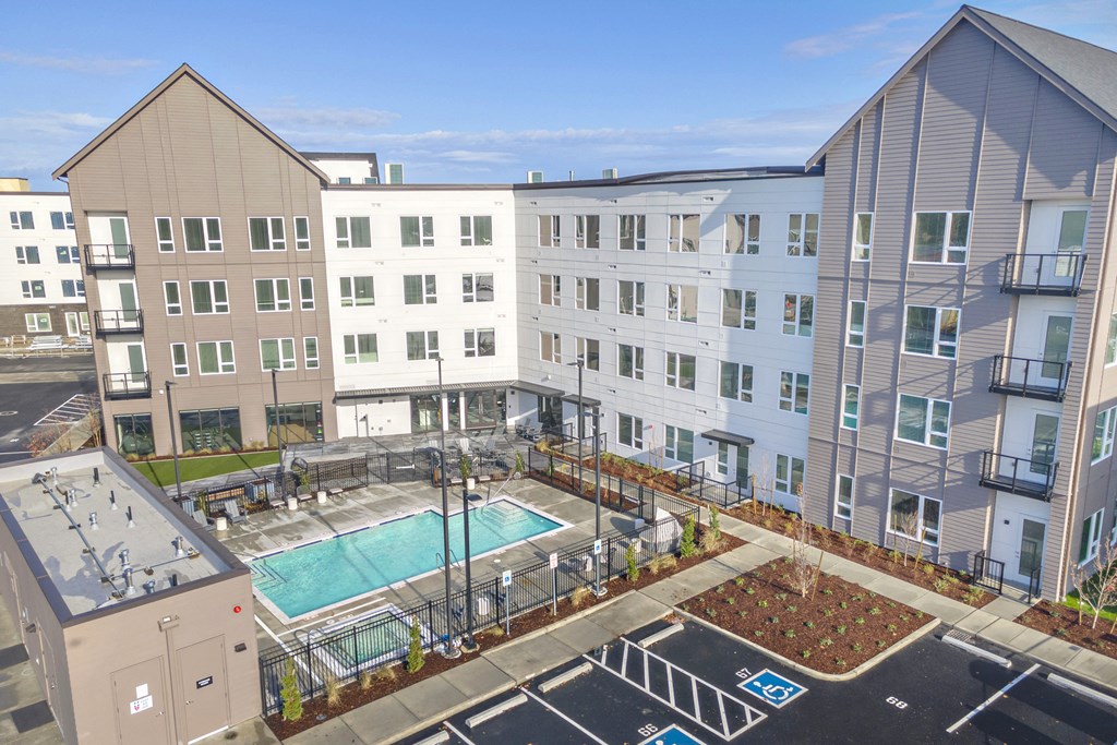 an apartment building with a swimming pool in the middle