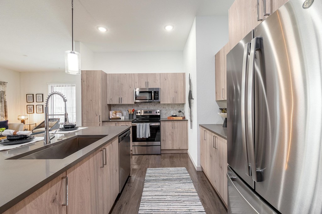 Large Kitchen with Stainless Steel Appliances and Wooden Cabinets at AVILA Apartments, Oviedo