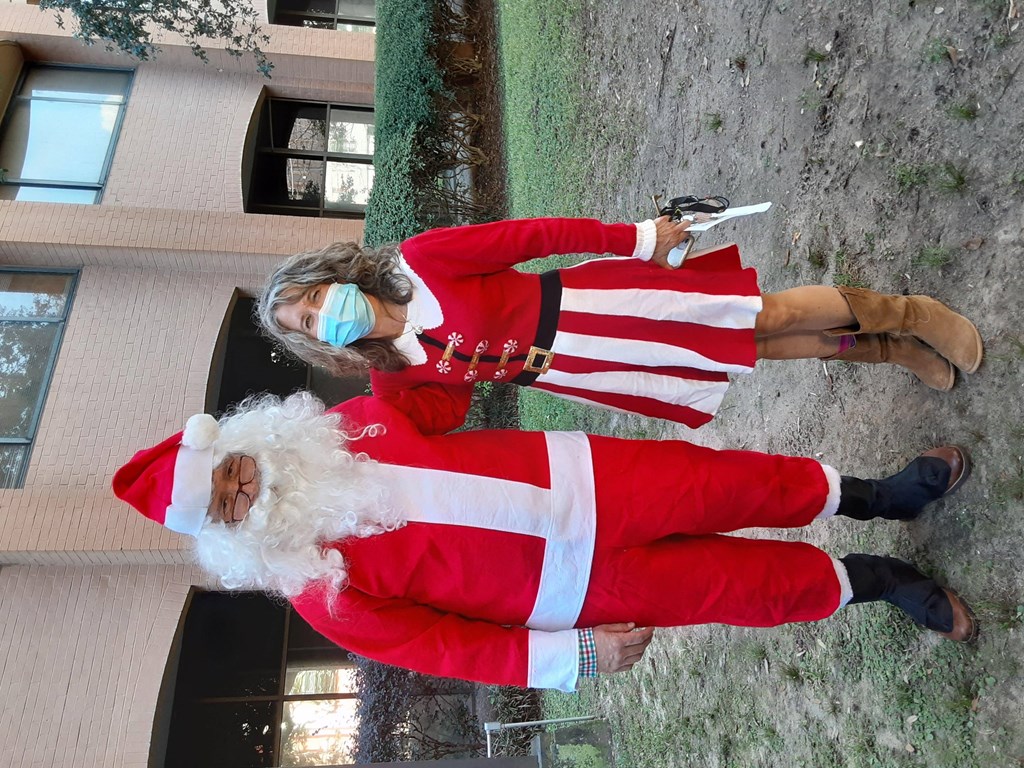 a man dressed as father christmas and a woman dressed as santa claus