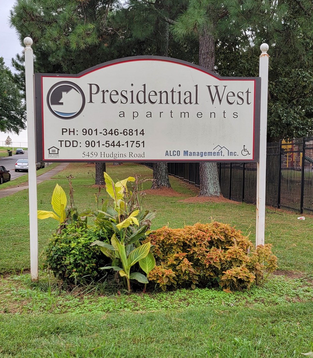 a sign for the presidential west apartments in a park