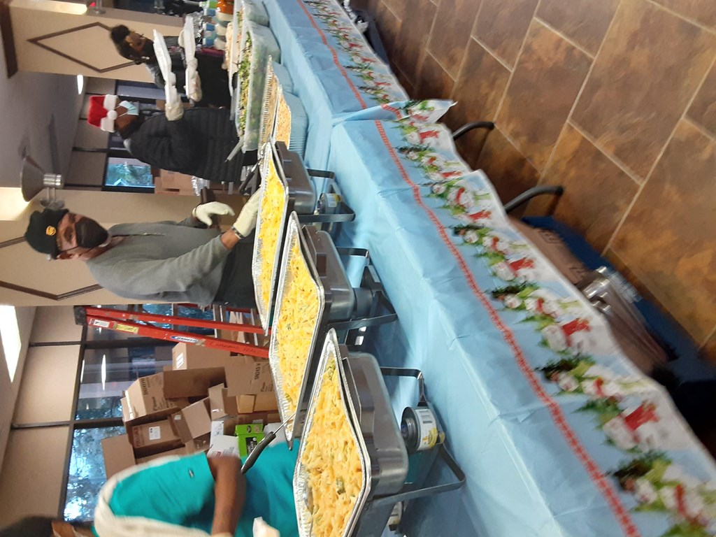 people working on a long buffet table in a restaurant