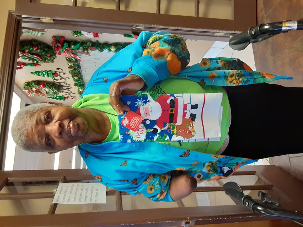 a man in a blue shirt is laying on a table with a glass table top