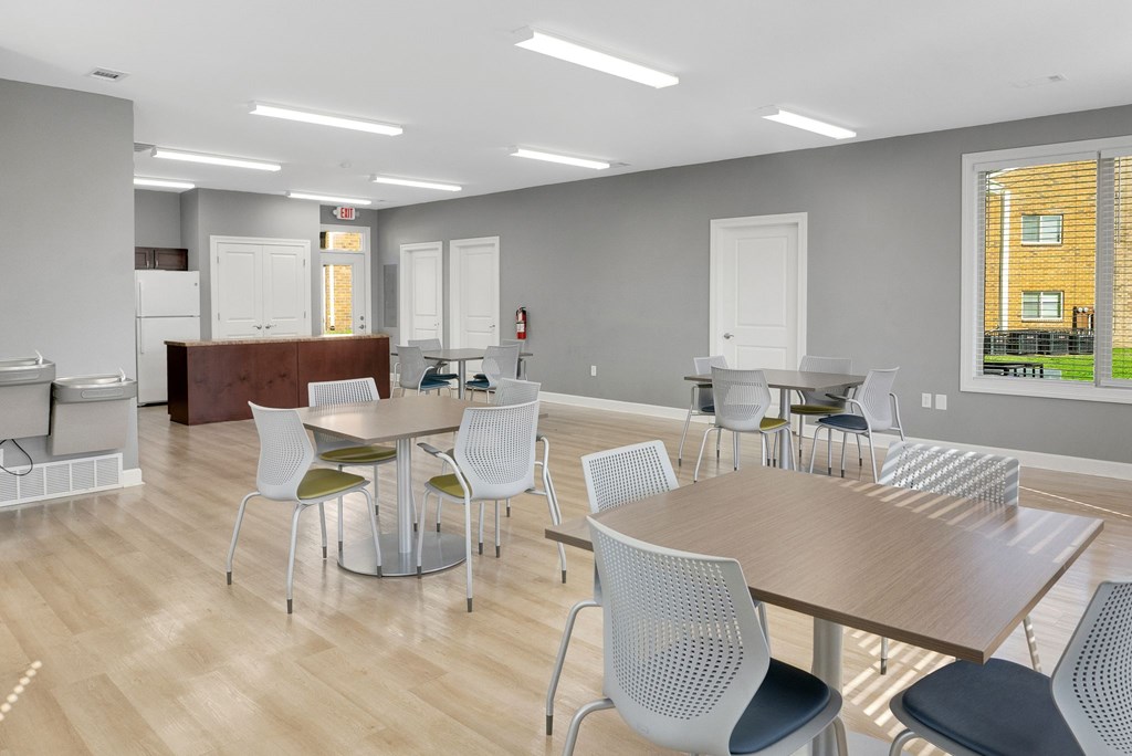 A conference room with a long table surrounded by chairs.