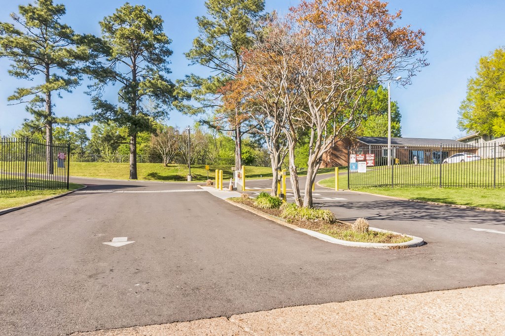 A roundabout with a yellow post in the middle of it.