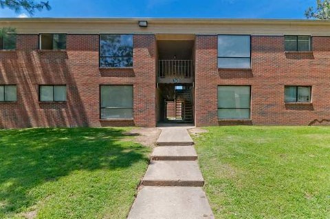 a brick building with a sidewalk in front of it