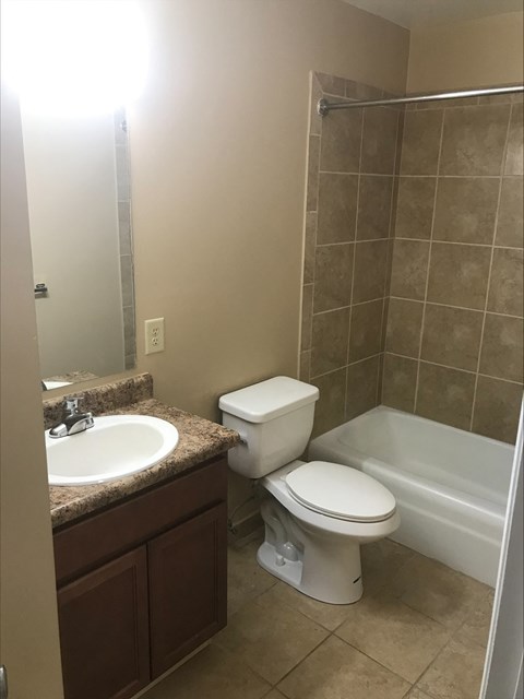 a bathroom with a toilet and a sink and a shower