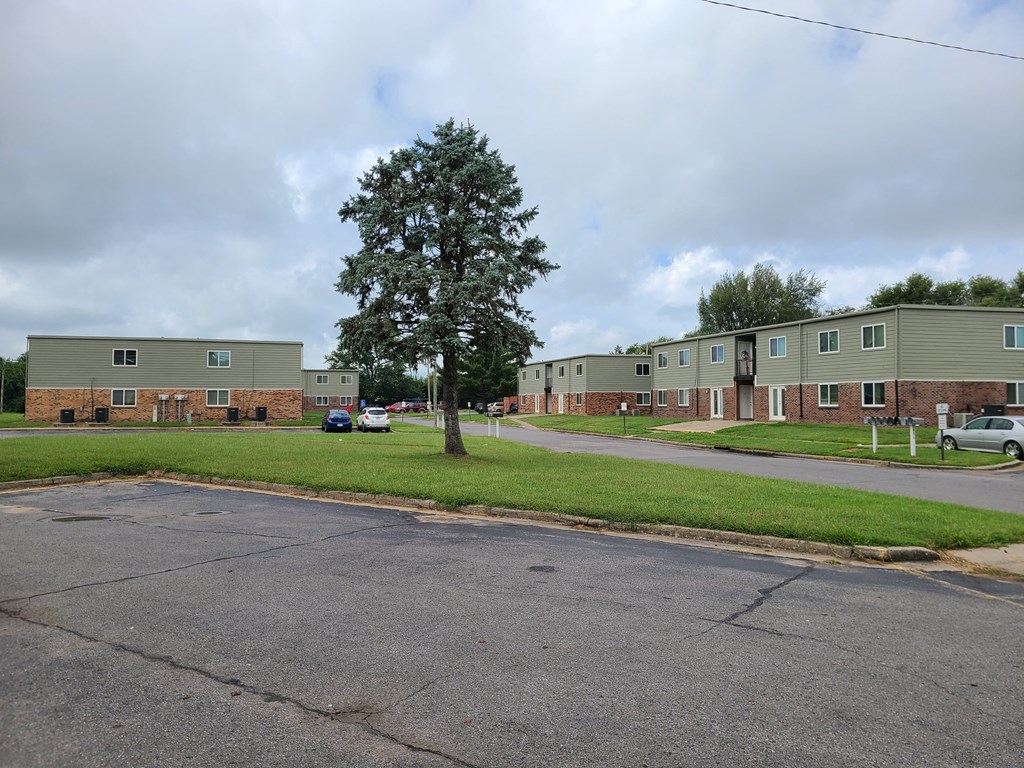 a row of apartment buildings on the side of a road
