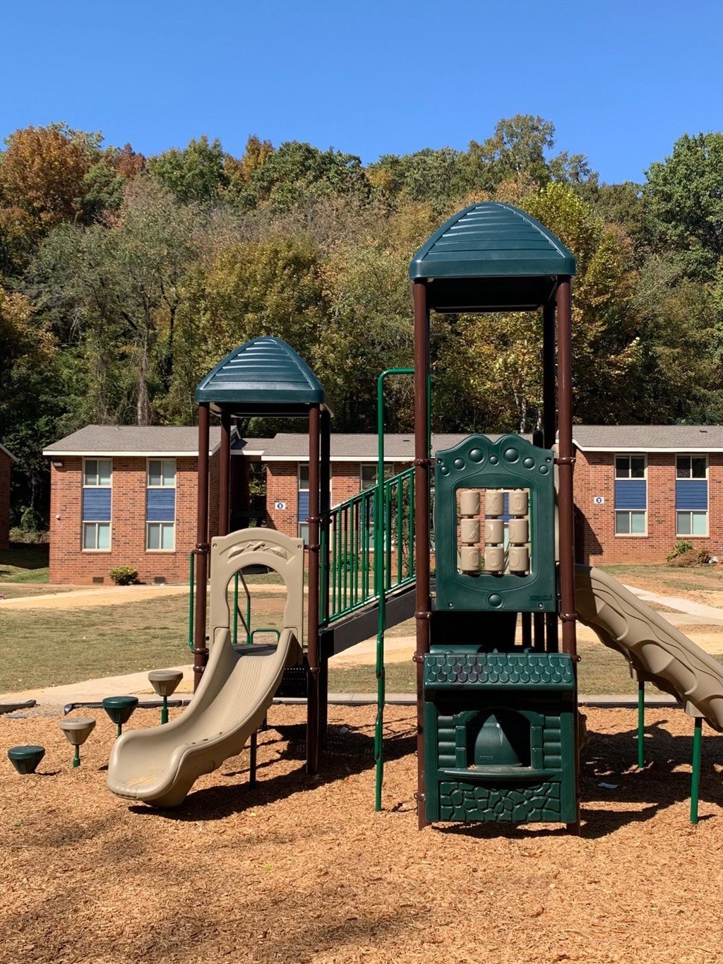 a playground with a slide and a climbing tower