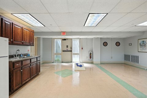 A kitchen with a green mat on the floor.