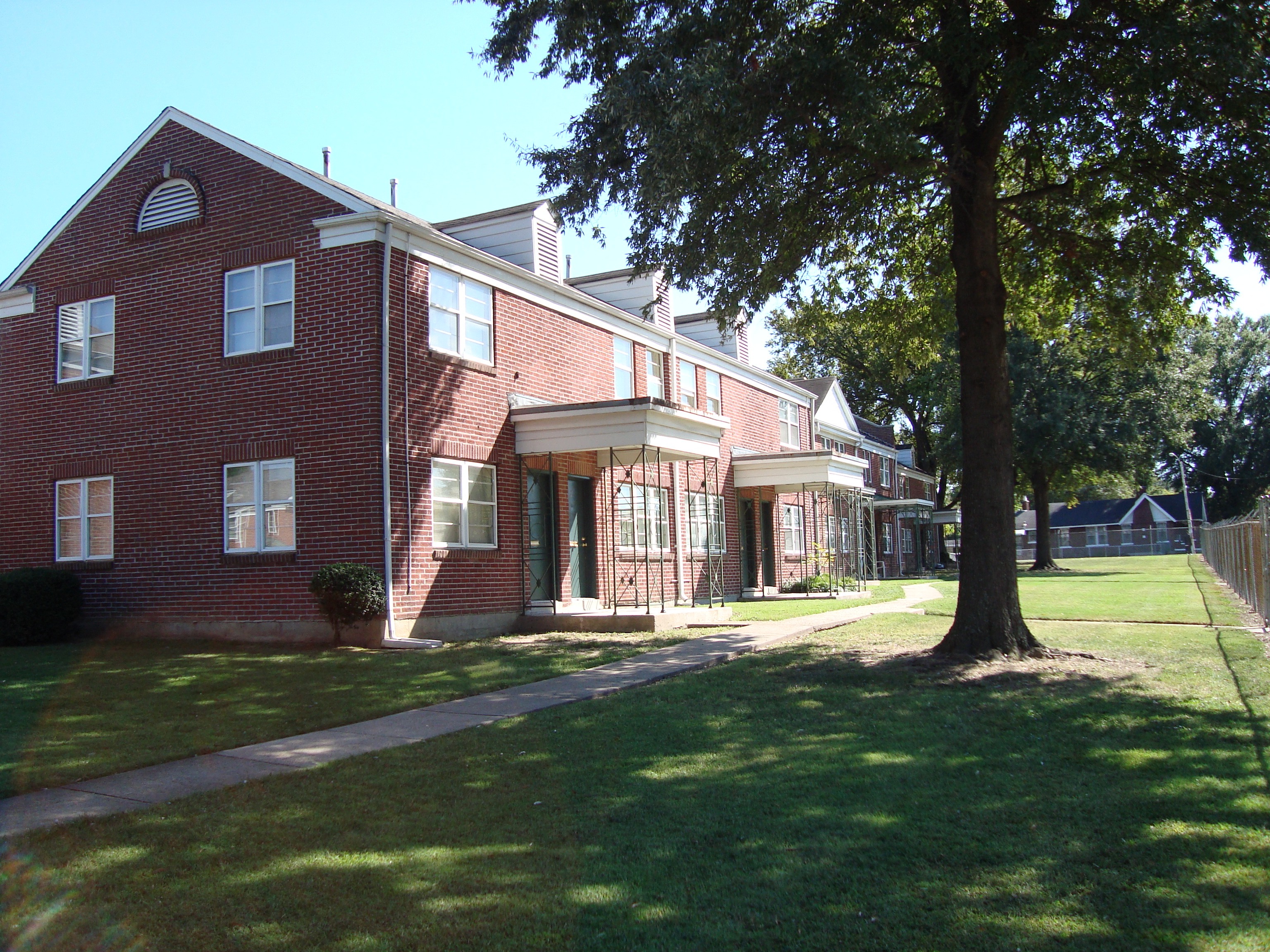 a view of the exterior of a red brick apartment building