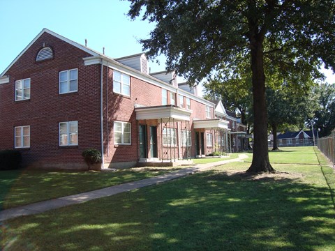 a view of the exterior of a red brick apartment building