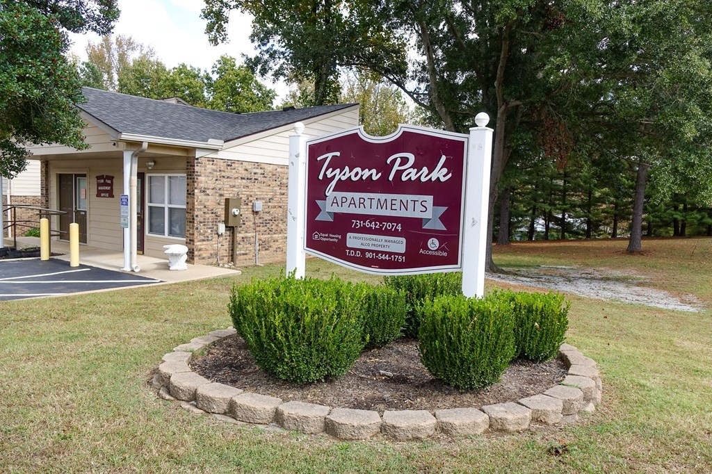 a building with a sign that says tyson park apartments