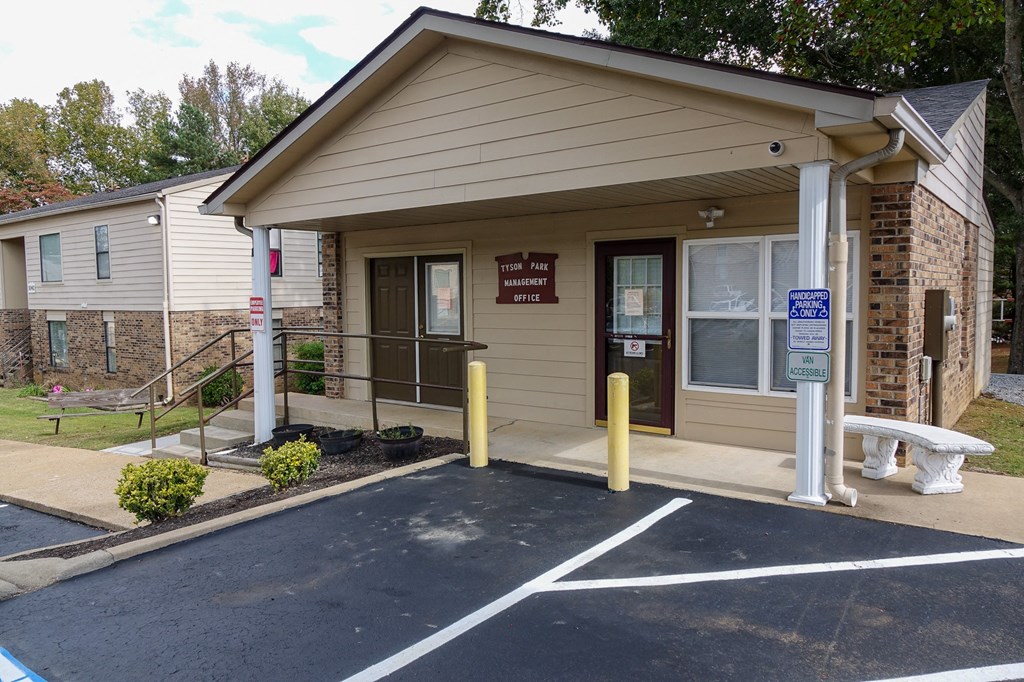 a small building with a ramp and a bench in front of it