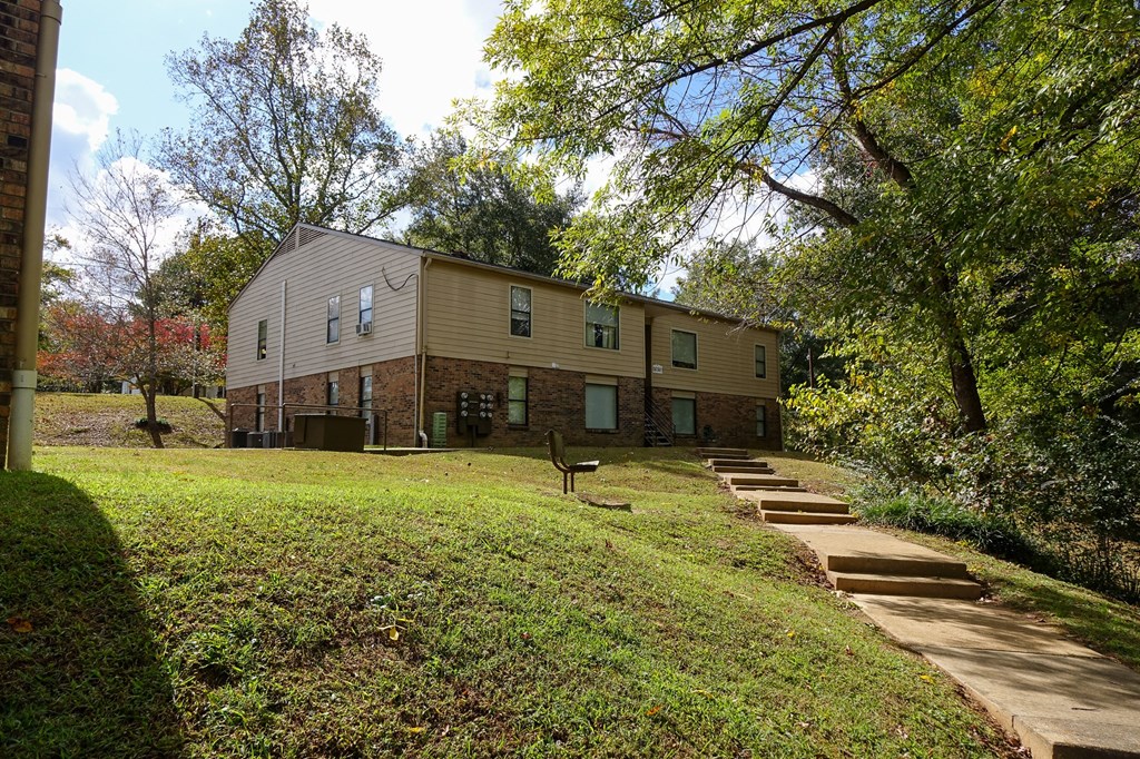 a picture of the back of a house with stairs leading up to it