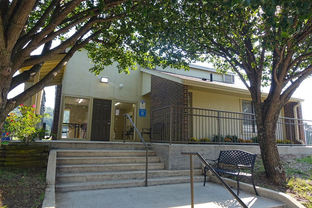 a building with stairs and a bench in front of it