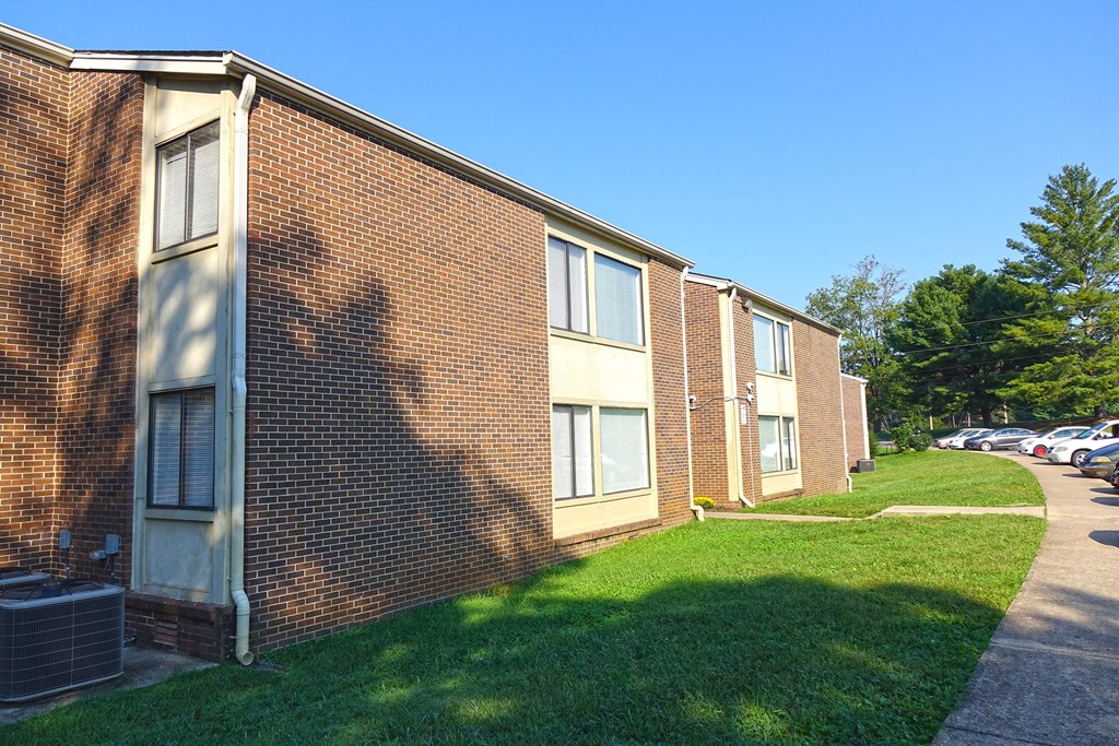 a brick building with a grassy area in front of it