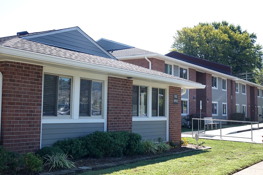 a brick house with a yard in front of it