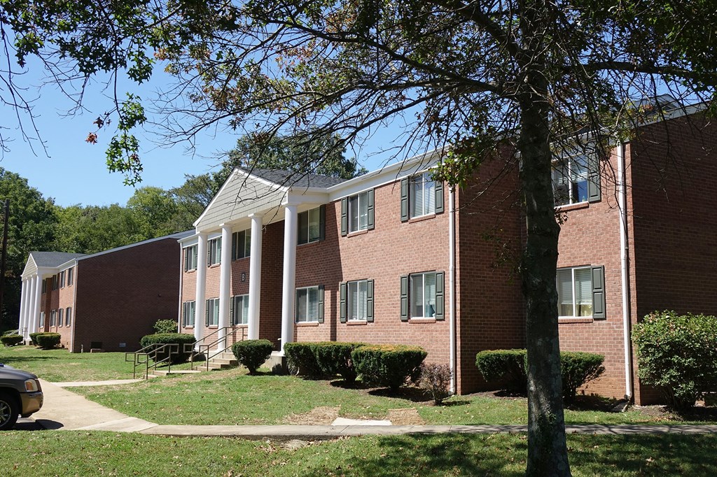 a brick building with a tree in front of it