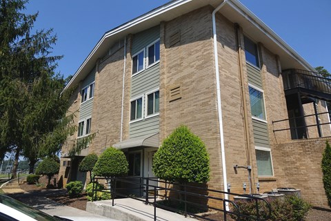 an apartment building with a brick facade and a balcony