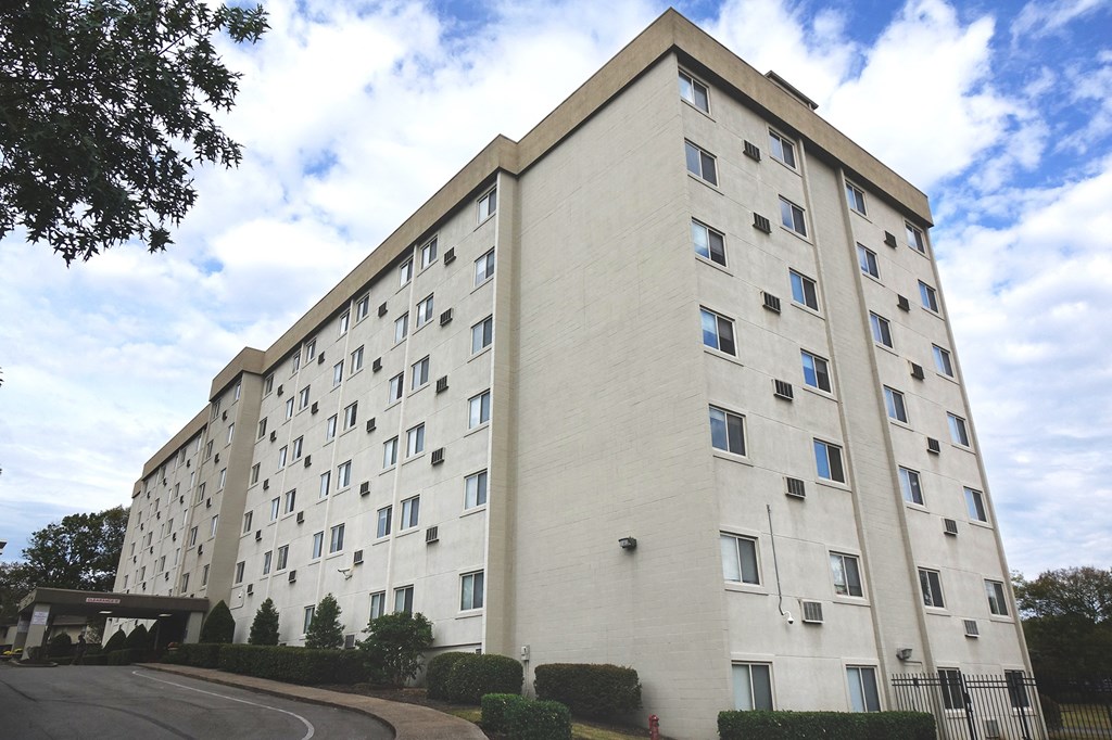 a large white building with a street in front of it