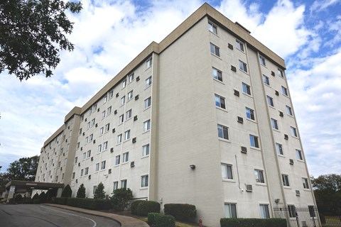 a large white building with a street in front of it